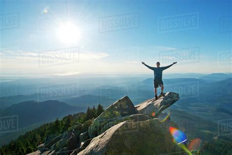 Hiker Standing On Top Of Mountain Stock Photo Dissolve