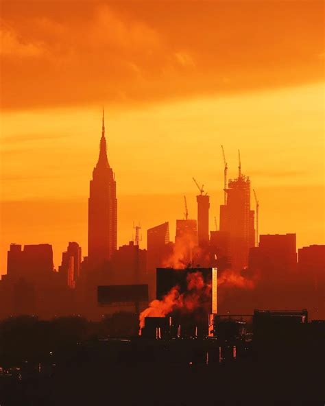 A Striking Orange Sunset Over Manhattan Phot Nyc Tourism Sunset