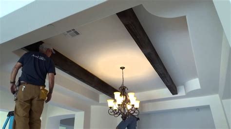 Traditional ceiling beams are actually wooden joists left exposed across the ceiling rather than boxed in or hidden above a ceiling. How to Install Faux Wood Ceiling Beams | Doovi