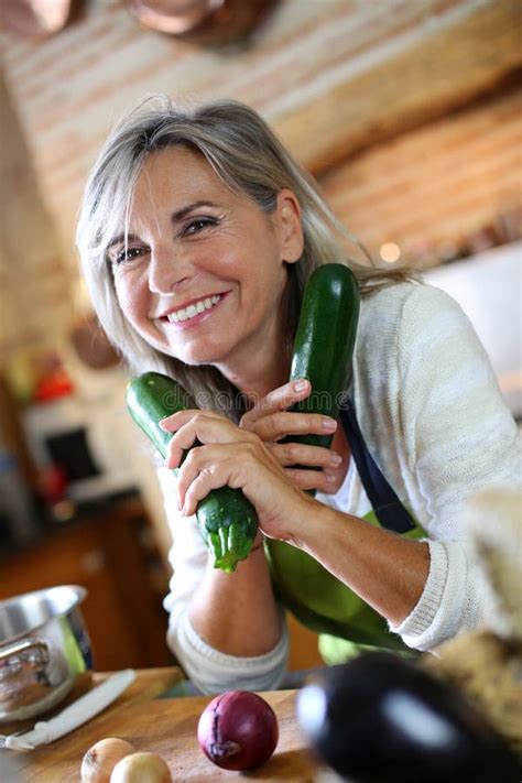 Mature Woman Holding Vegetables For Cooking Stock Image Image Of Apron People 33917467
