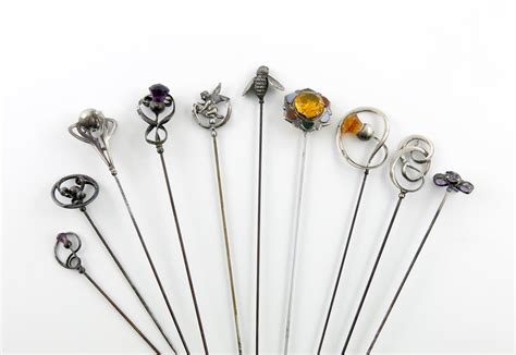 A Collection Of Ten Silver Hat Pins Comprising A Silver And Hard