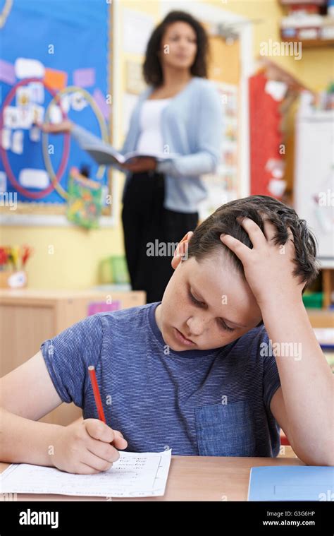 Male Elementary School Pupil Struggling In Class Stock Photo Alamy