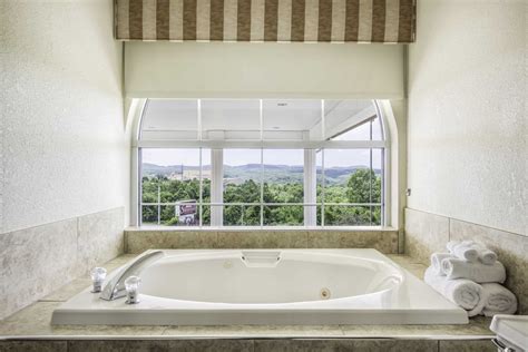 Swimming pool and hot tub with natural light. King Suite With Jetted Tub | Savannah House Hotel in ...