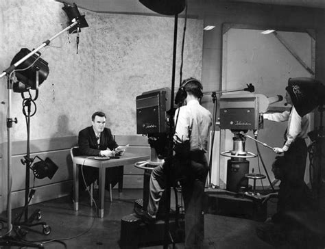 Black And White Photograph Of Two Men In Front Of Camera Set Up For An