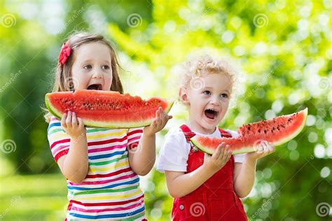 Kids Eating Watermelon In The Garden Stock Image Image Of Friend