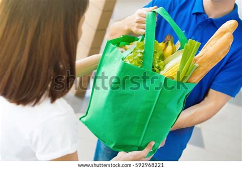 Delivery Man Giving Grocery Bag Woman Stock Photo 592968221 Shutterstock
