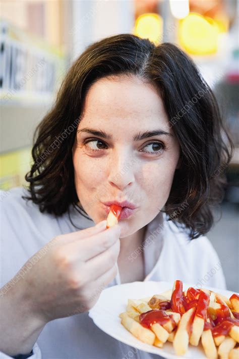 Woman Eating French Fries Stock Image F003 7385 Science Photo Library