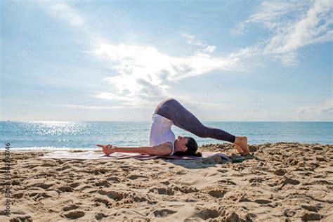 Caucasian Flexible Woman Practicing Yoga In Plow Pose Halasana