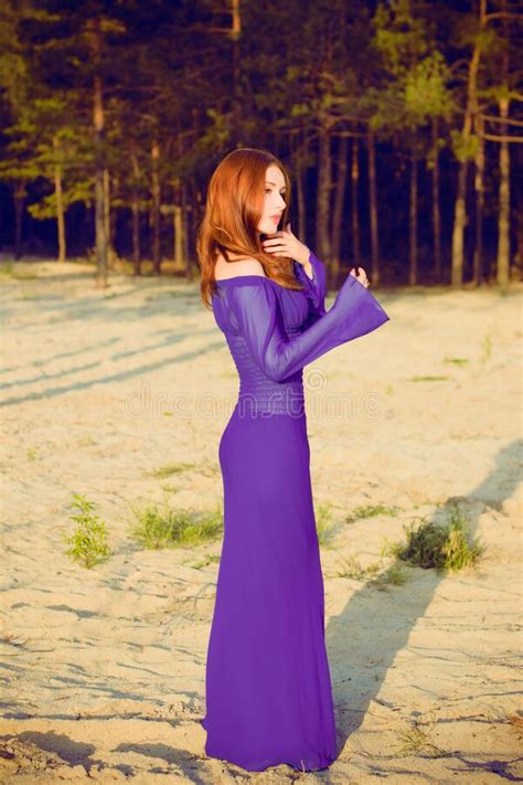 Woman In Purple Long Dress At Nature Fashionable Concept Stock Image
