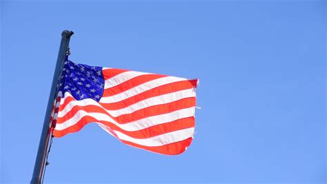 American Usa Us Flag Waving Over Blue Sky Background 4k Uhd Stock