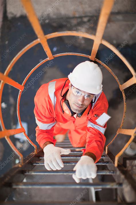 Worker Climbing Ladder At Oil Refinery Stock Image F0053669