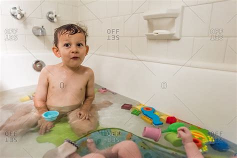 Boy In A Bathtub With Toys And His Baby Brother Stock Photo Offset