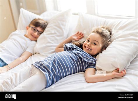 Brother And Sister Having Fun Together On Bed Stock Photo Alamy