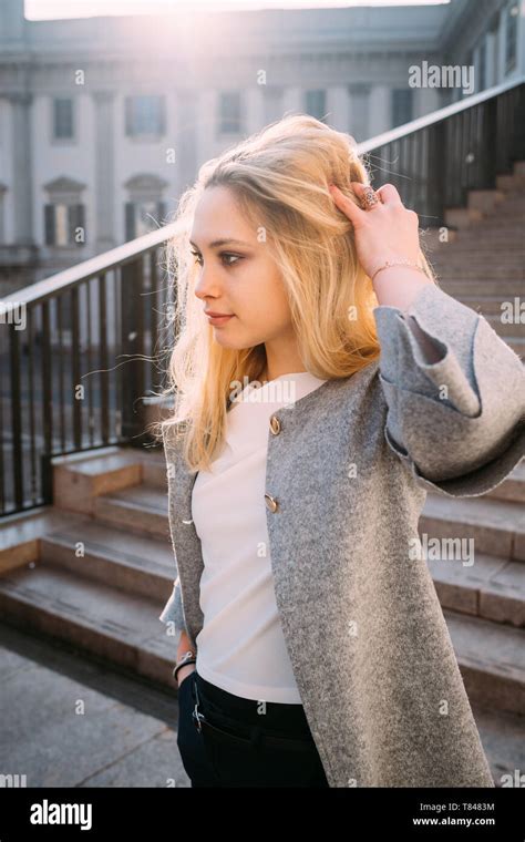 Young Woman With Long Blond Hair On Stairway Milan Italy Stock Photo
