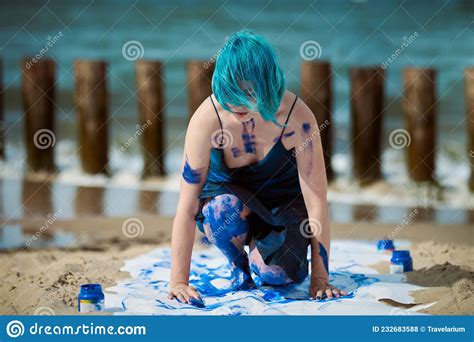 Artistic Blue Haired Woman Performance Artist Smeared With Gouache Paints On Large Canvas On