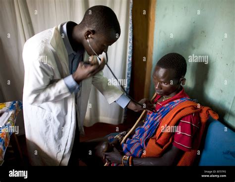 A Kenyan Doctor Investigates A Massai Patient In A Local Clinic Stock Photo Alamy