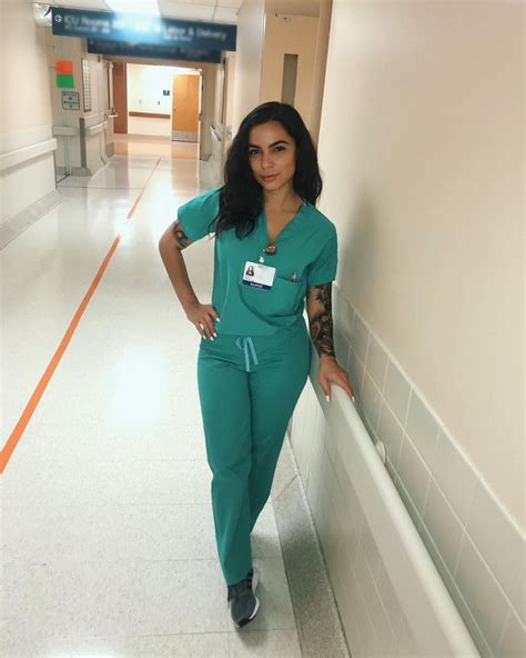 image may contain 1 person standing shoes and indoor nurse fashion scrubs