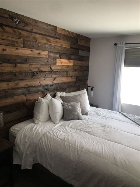 White wicker bedroom furniture ideas. Reclaimed wood wall | Wood walls bedroom