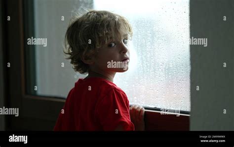 Pensive Child Looking Out Window During Rainy Day Thoughtful Young Boy