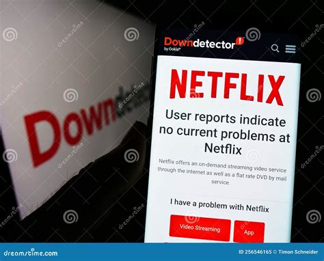 Person Holding Smartphone with Website of Platform Downdetector and