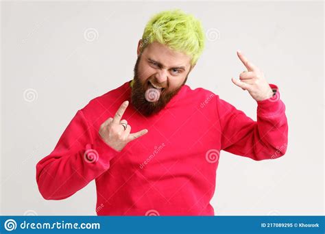 Portrait Of Carefree Excited Persons Howing Tongue And Heavy Metal Symbol With Two Arms Fingers