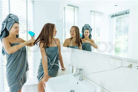 Mom Brushing Hair To Her Daughter In Hotel Bathroom Stock Image