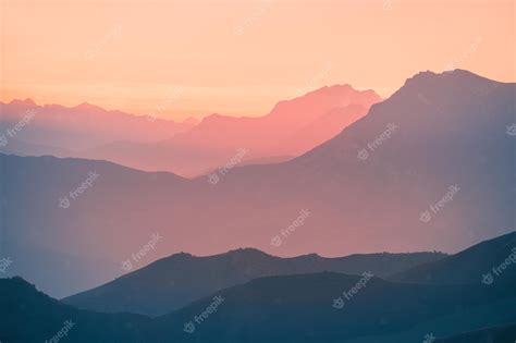 Premium Photo Mountain Range In Pink Sunlight At Sunset Blue