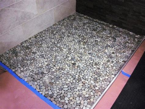 Each sheet of the 12 x 12 interlocking pebble tile has approximately 60 handpicked stones bonded to a sturdy mesh backing. How to Lay a Pebble-Tile Floor | how-tos | DIY
