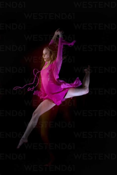 Female Ballet Dancer Jumping In Air Stock Photo