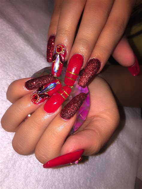 long coffin shaped, red acrylic nails with glitter and ... You can't imagine any female style without red.