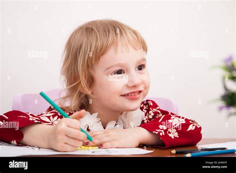 Little Girl Drawing With Colored Pencils On Paper Stock Photo Alamy