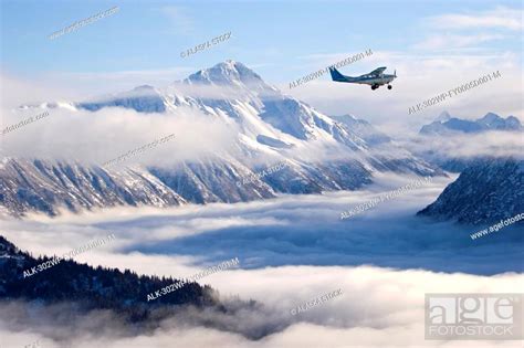 Cessna 206 Flying Over Cloud Shrouded Kachemak Bay State Park And Sadie