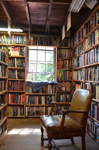A Chair Sitting In Front Of A Book Shelf Filled With Books