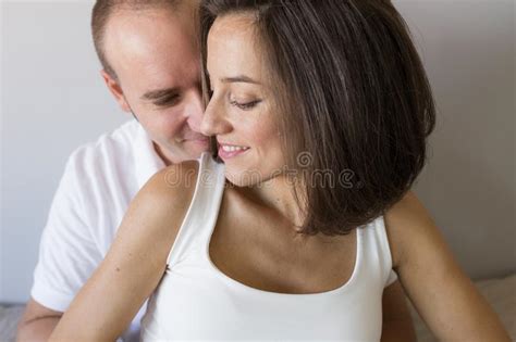 Beautiful Pregnant Woman And Her Handsome Husband Are Hugging And Smiling While Spending Time