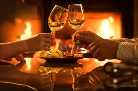 Young Couple Have Romantic Dinner With Wine Over Fireplace