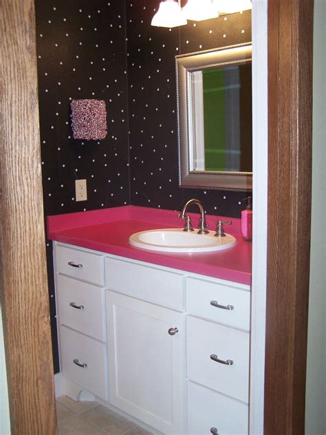 Girls Bathroom With Hot Pink Laminate Countertops And White Cabinets By