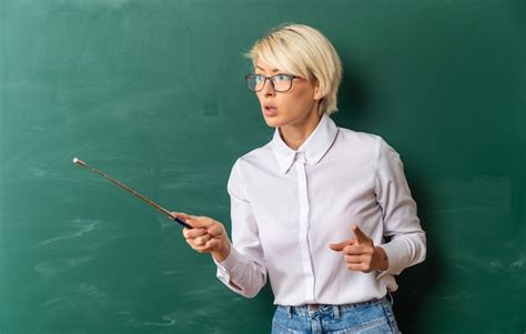 Free Photo Strict Young Blonde Female Teacher Wearing Glasses In