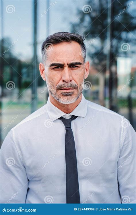 Vertical Individual Portrait Of Serious Mature Businessman Looking