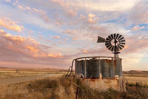 Image Of Windmill And Old Rusty Water Tank At Sunset Austockphoto