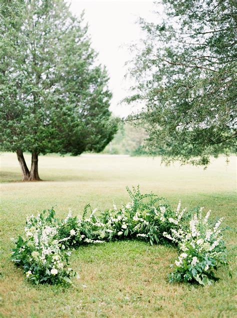 A Wedding Ceremony Trend Were Loving Grounded Floral Arches Circular Wedding Arch Floral