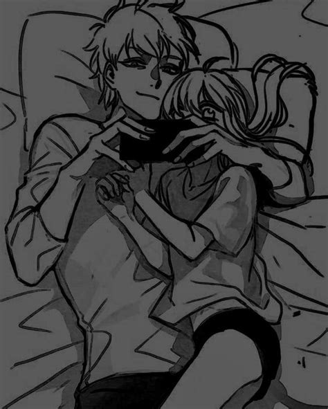 Two People Laying In Bed With One Holding The Others Arm Around His Neck