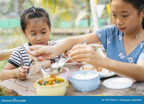 Two Girl Eating Food From Pinto Box Stock Photo Image Of Carrier