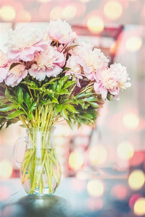 Lovely Pink Peonies Flowers Bunch In Vase At Sunshine Bokeh Stock Photo