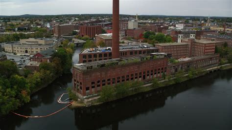 5 5k stock footage aerial video flying by riverside abandoned factory and smoke stack autumn