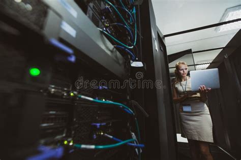 It Engineer Standing Before Working Server Rack Doing Routine