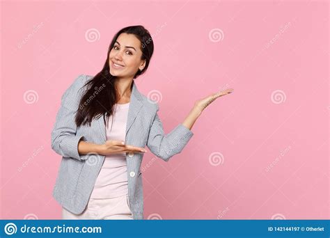 Portrait Of Attractive Smiling Young Woman In Striped Jacket Pointing Hands Aside Isolated On