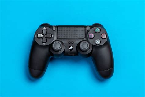 Setting the ps4 background image. Flat Lay Photo of Black Sony PS4 Game Controller on Blue ...