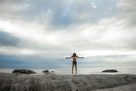 Woman Jumping On A Rock At Sunset On Bakovern Beach Cape Town Stock Photo Image Of Jump