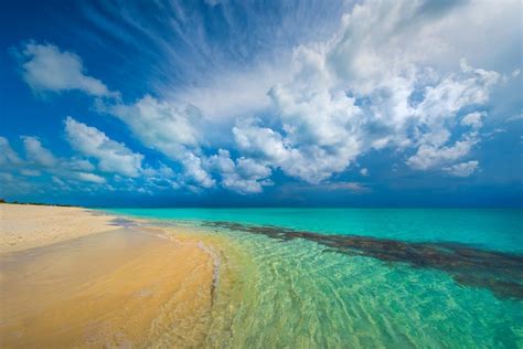 nature landscape tropical beach caribbean island turquoise sea white clouds sand