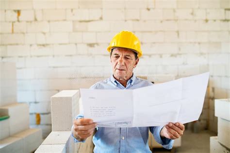 Senior Architect Or Civil Engineer At The Construction Site Stock
